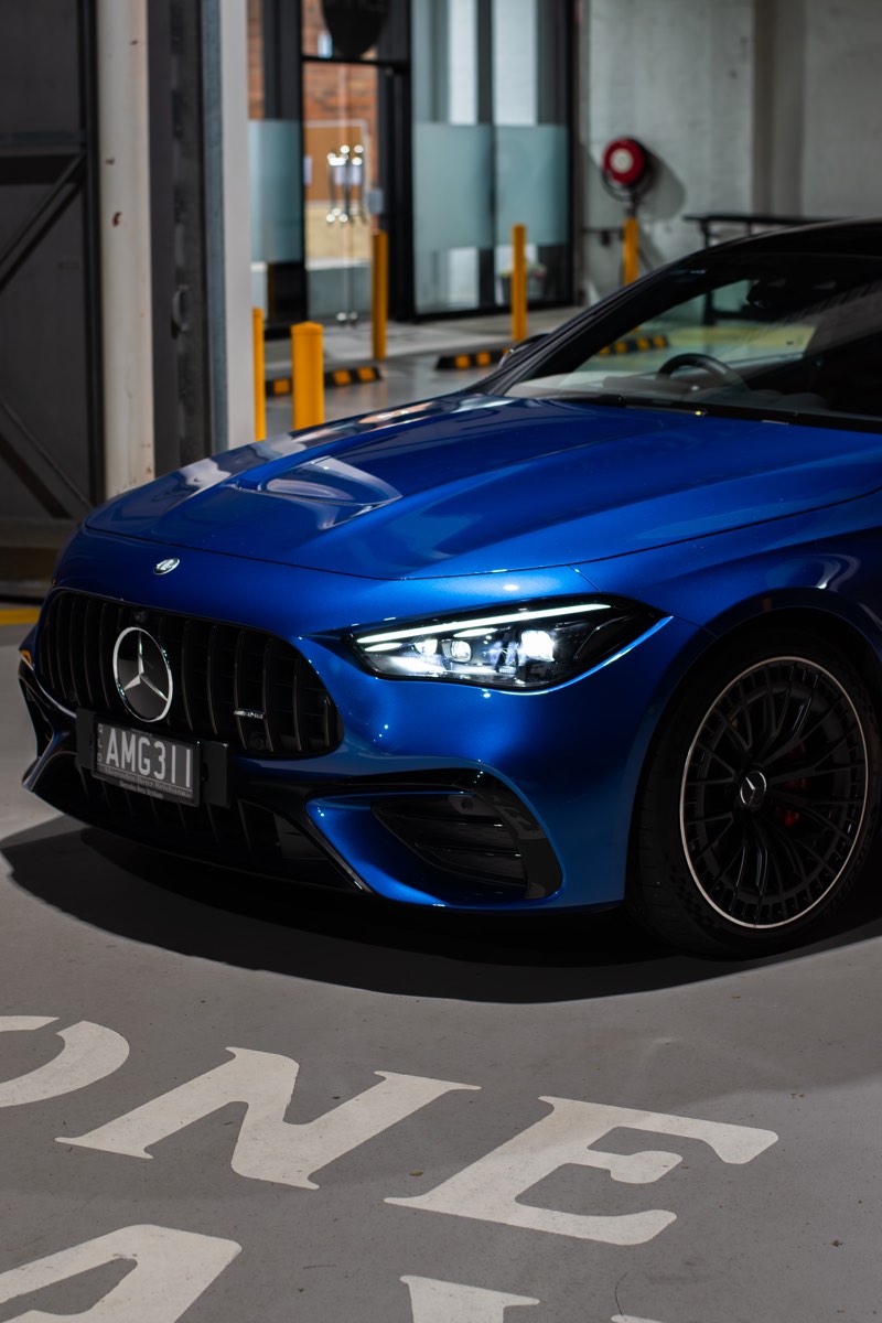 Close front-quarter detail of the Mercedes-AMG CLE53 under industrial night lighting