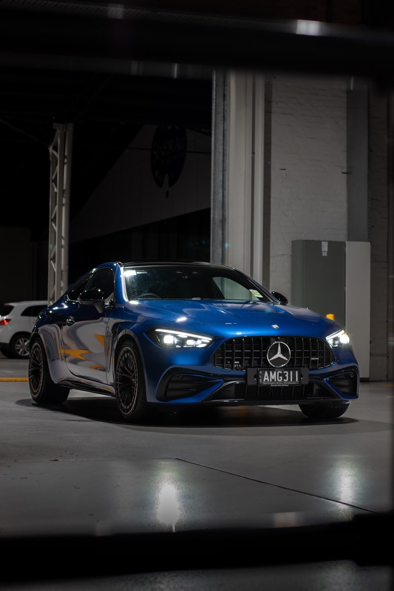 Mercedes-AMG CLE53 coupe photographed at night in an industrial location